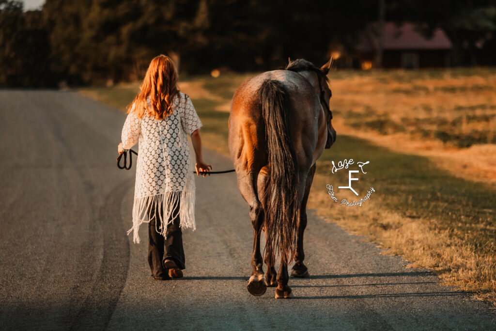 Kendall walking with horse away from camera