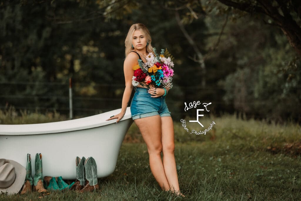 Reid leaned against white tub with flower pants