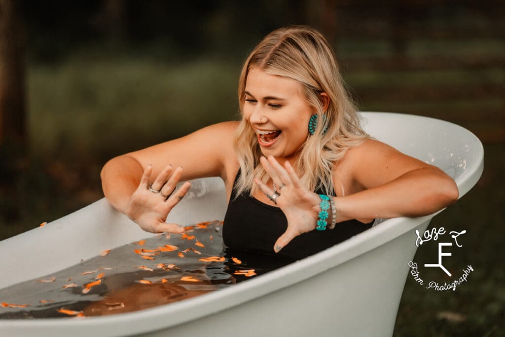 Reid getting into cold bath water with flower petals