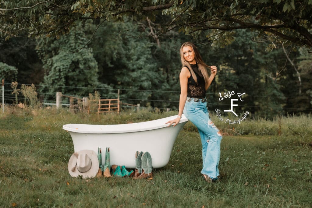 Sierra standing in black top leaned against bath tub