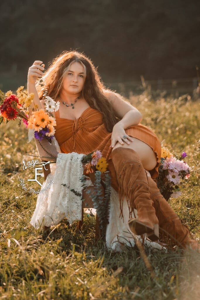 Savannah in rust dress and brown boots in flower chair