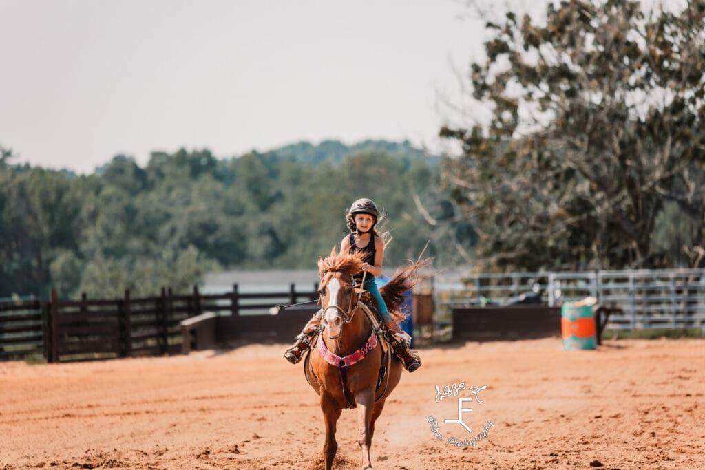 little girl on brown pony