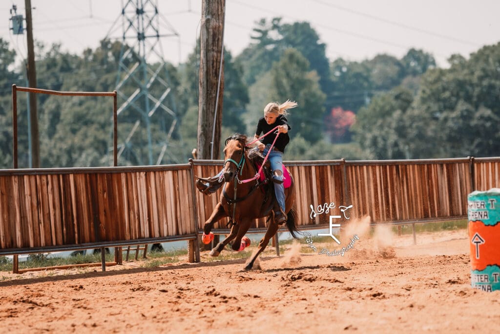 blonde girl coming around turn at gallop