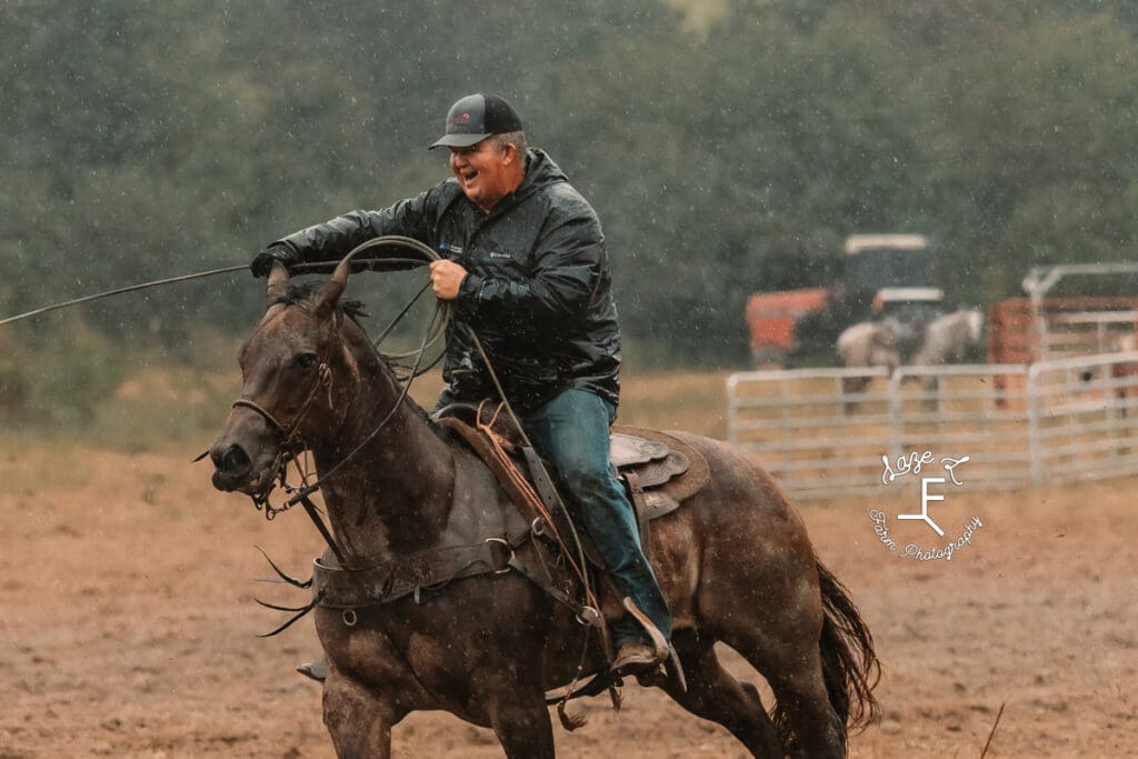 Team roper on wet horse