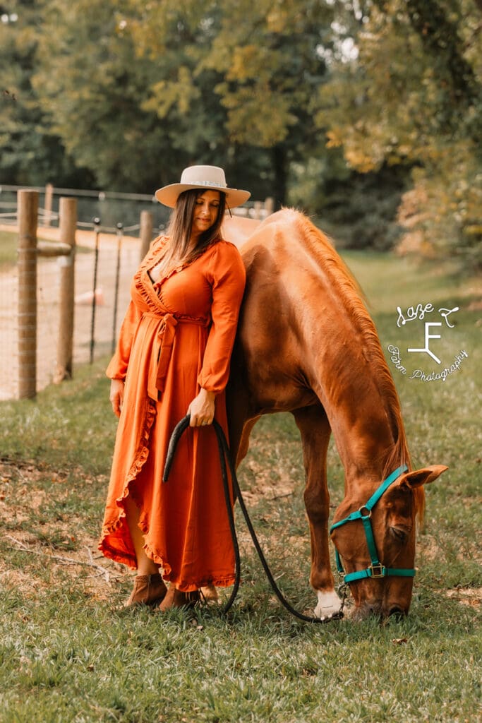 Andrea standing with Spartan while he eats