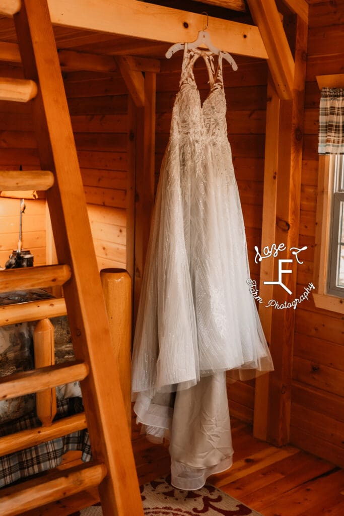 Brides dress hanging in cabin