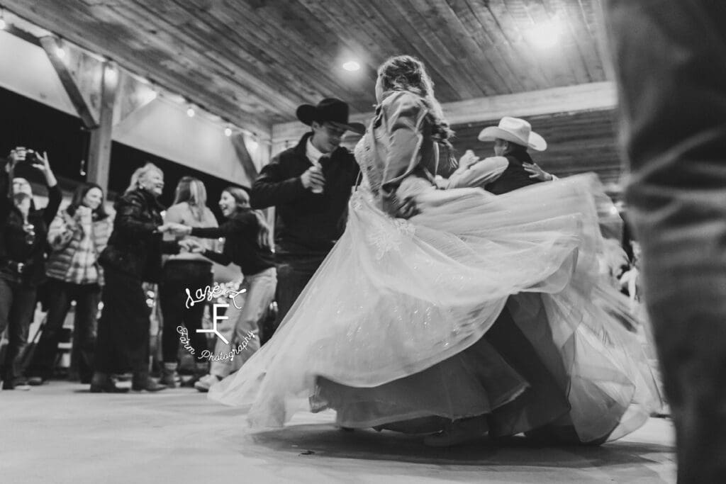 bride and groom dancing in black and white