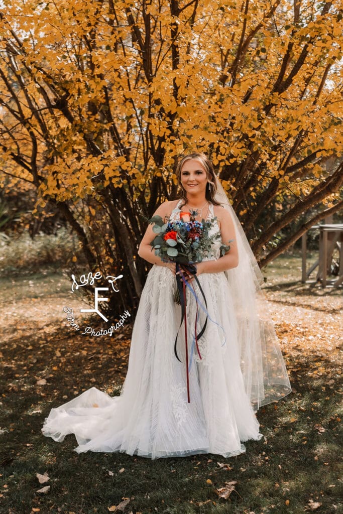 Bride in front of yellow butterfly bush