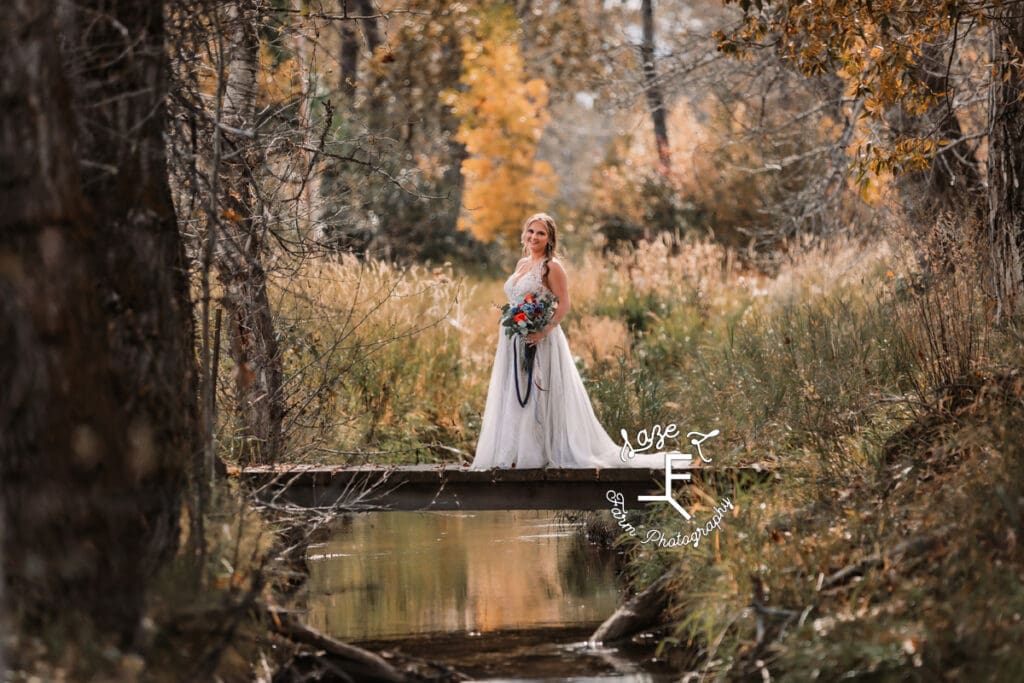 Bride on footbridge in woods