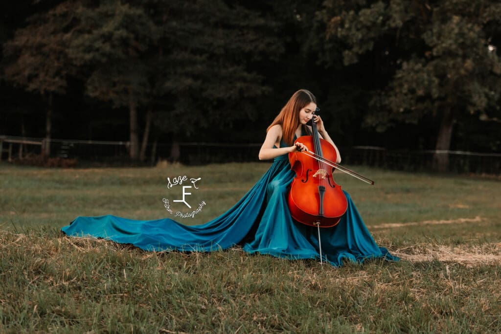 Natalie playing cello in long turquoise dress