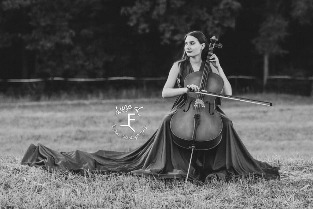 Natalie playing cello in long turquoise dress in black and white