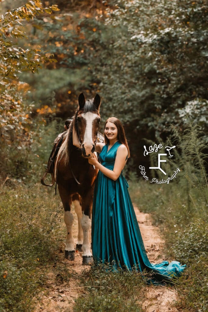 Natalie wearing turquoise dress with paint pony on trail