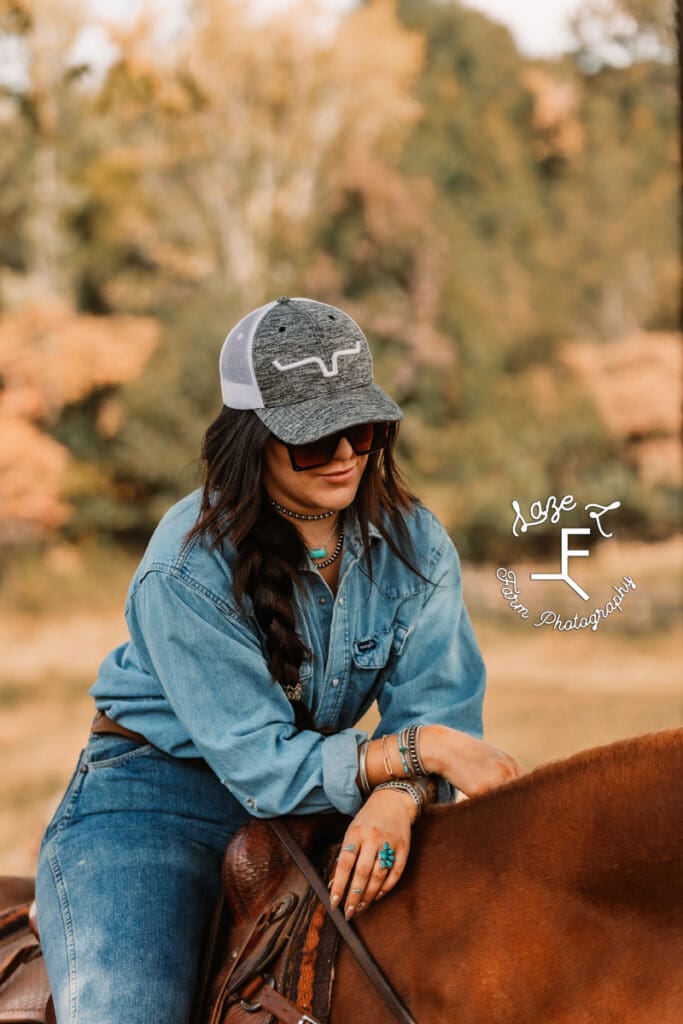 Halle showing rings leaning over saddle horn