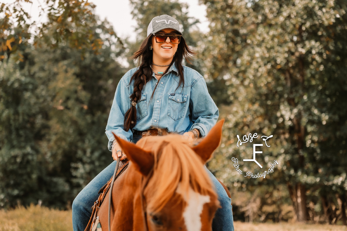 Halle riding Gus smiling