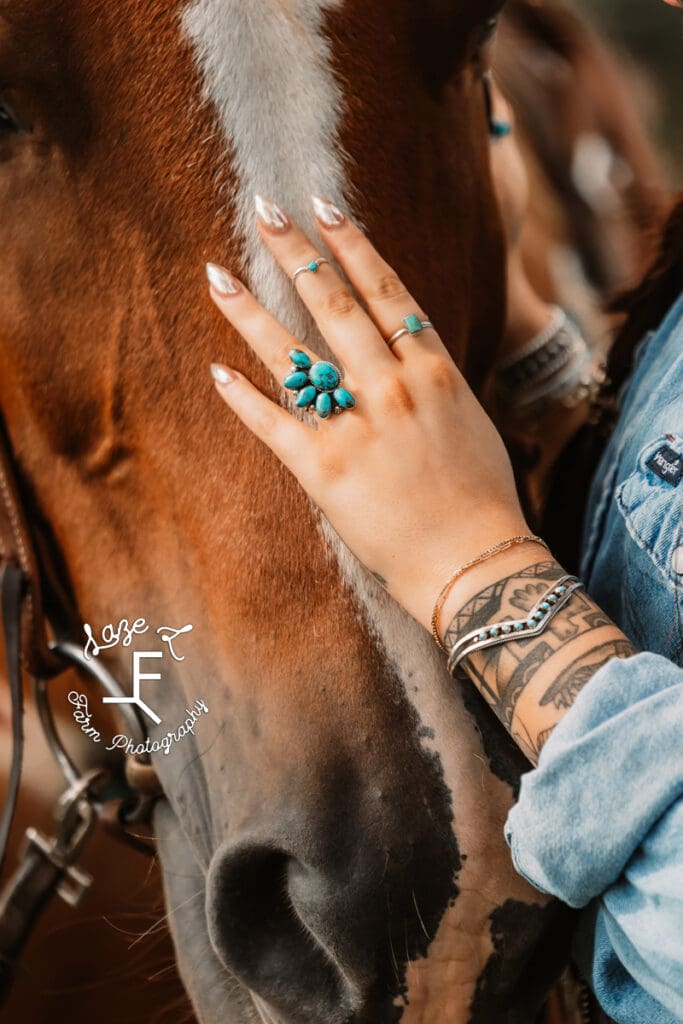 close up of Halle's hand with turquoise rings