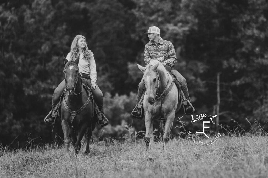 Taylor and Kyle riding their horses in black and white