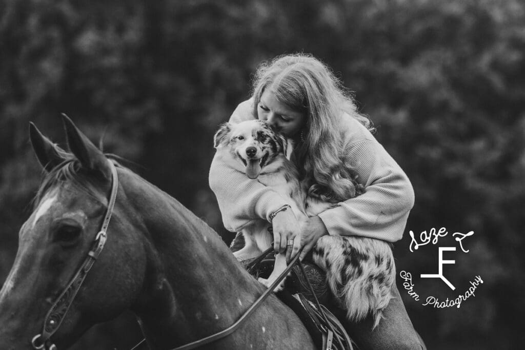 Taylor with her dog on her horse in black and white