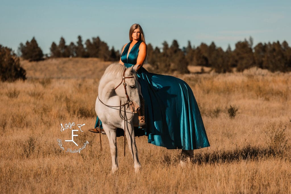 Cowgirl 1 on grey horse in turquoise dress