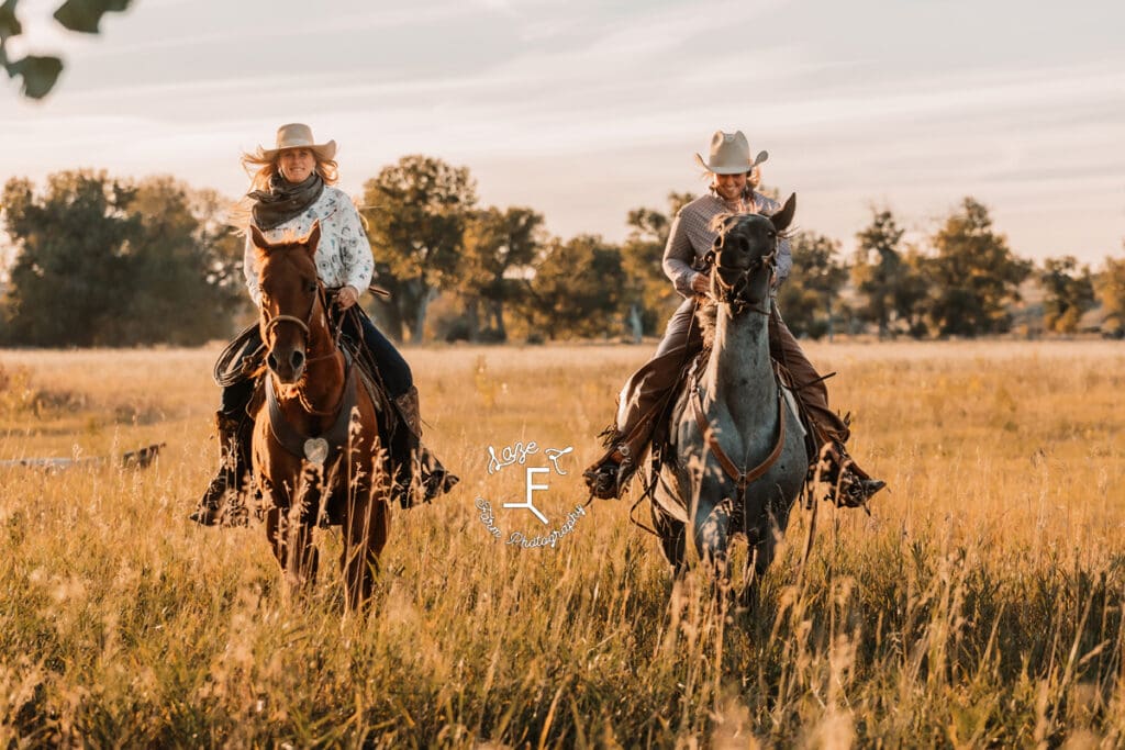 Cowgirls loping toward camera