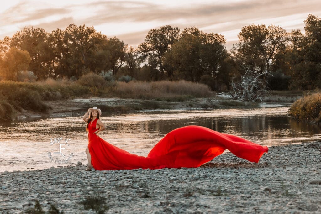 Cowgirl in red parachute dress by river