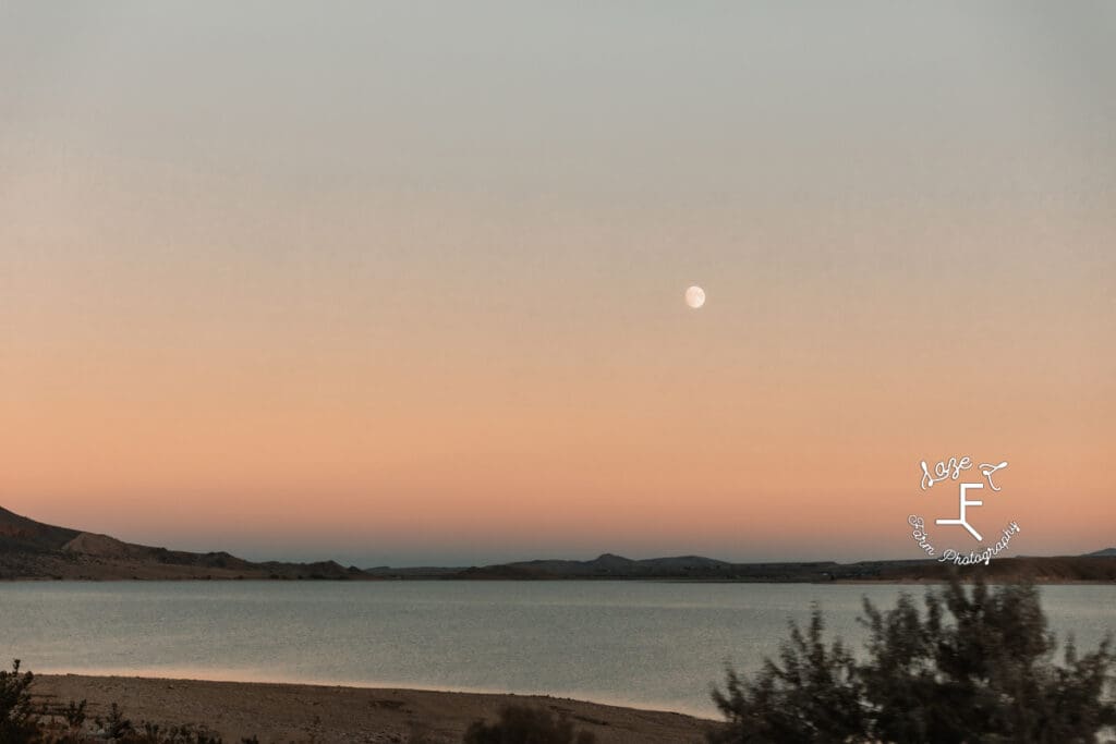 Lake at sunset with the moon