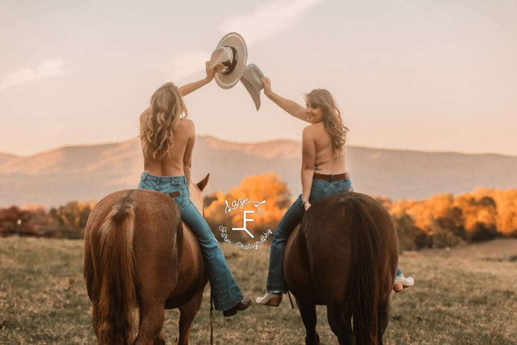 Cowgirls on horseback topless facing away from camera