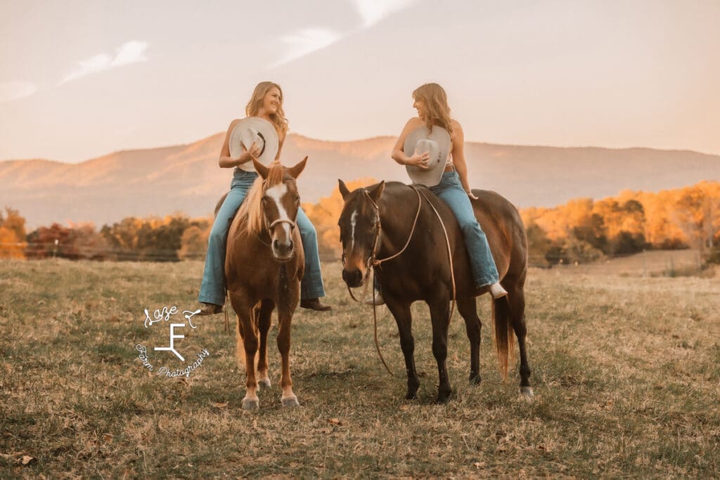 Cowgirls holding hats on horseback