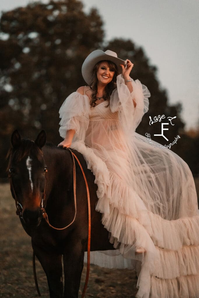 Cowgirl on horse back in flowy dress