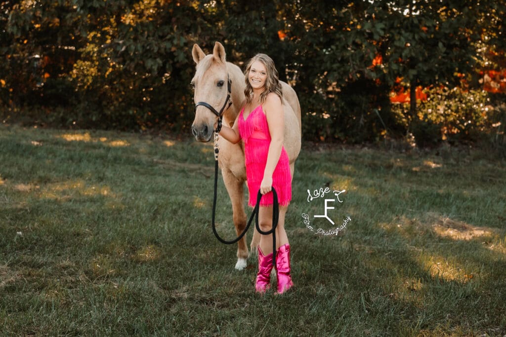 Kayla wearing pink fringe dress with hot pink boots and Ben