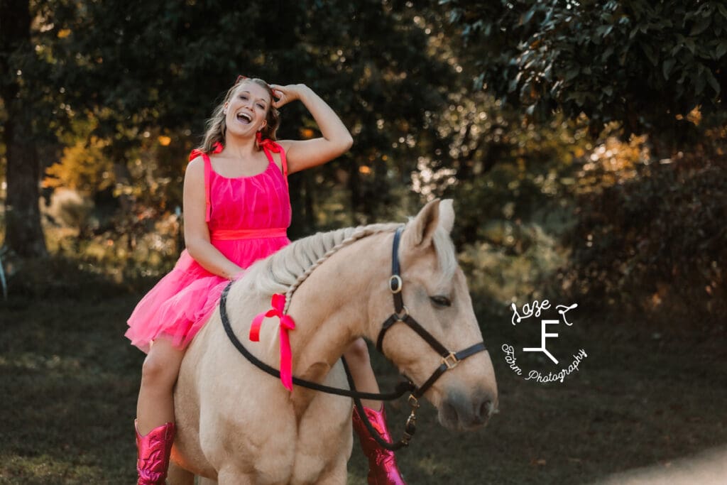 Kayla sitting on Ben with pink tulle dress pink boots and pink heart sunglasses