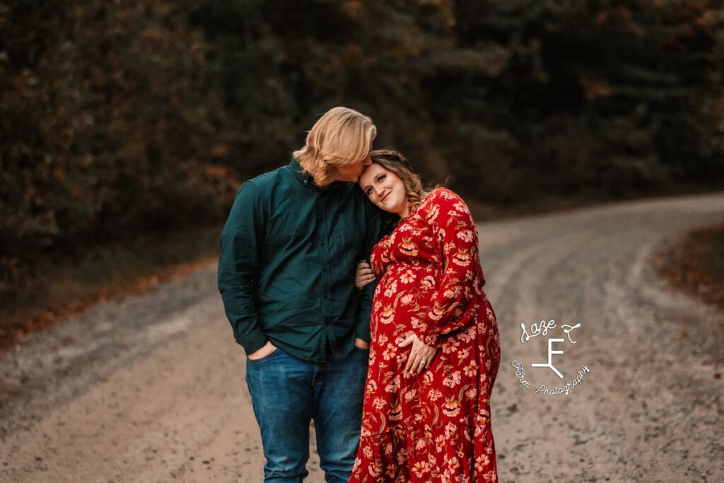 Ashley holding bump and Devin kissing her head