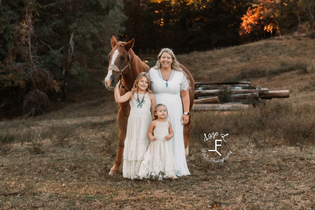 mom, 2 girls standing with horse