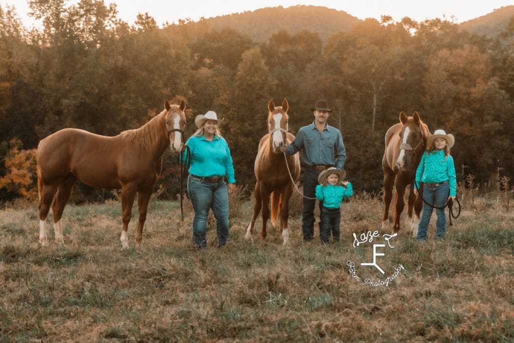 Mom, dad, 2 girls standing with 3 horses