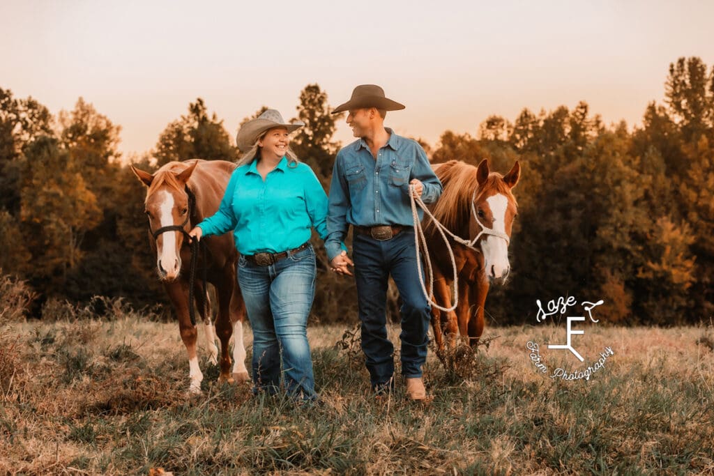 Husband and wife walking with 2 horses