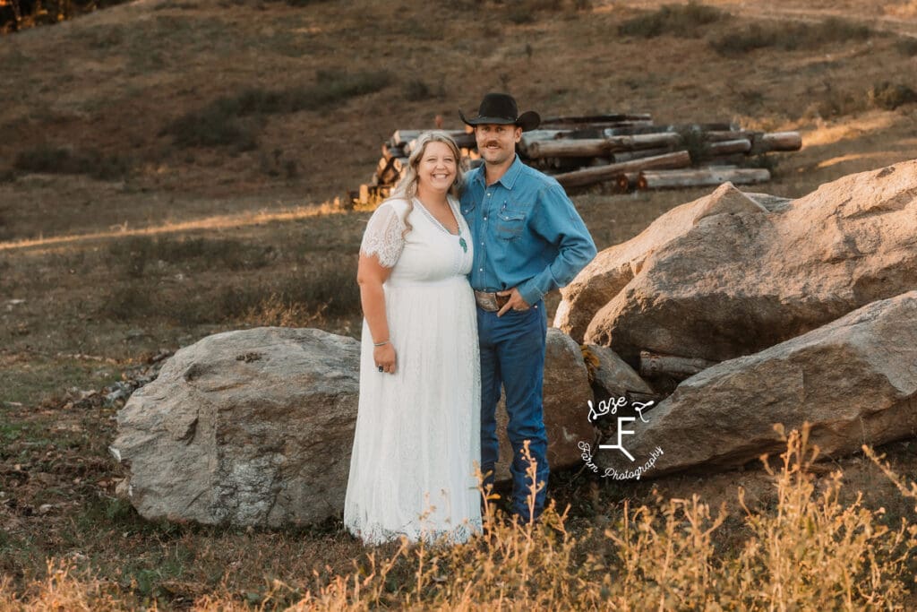 Cowboy husband and wife wearing a white dress