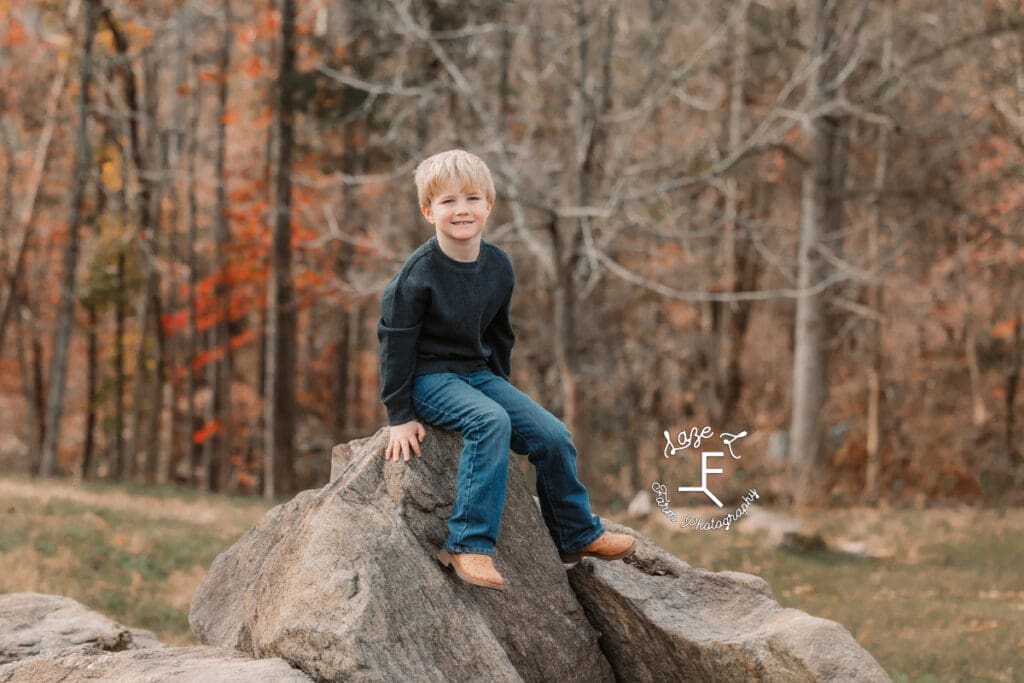 little brother sitting on rocks