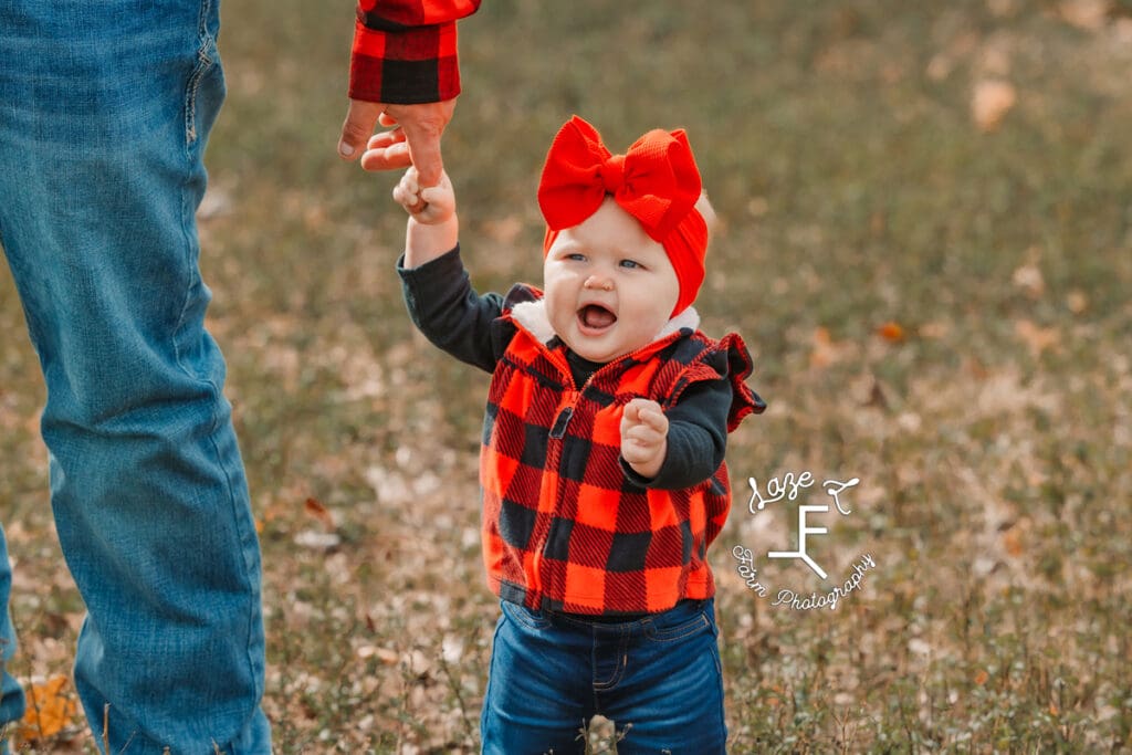 Baby sister standing smiling