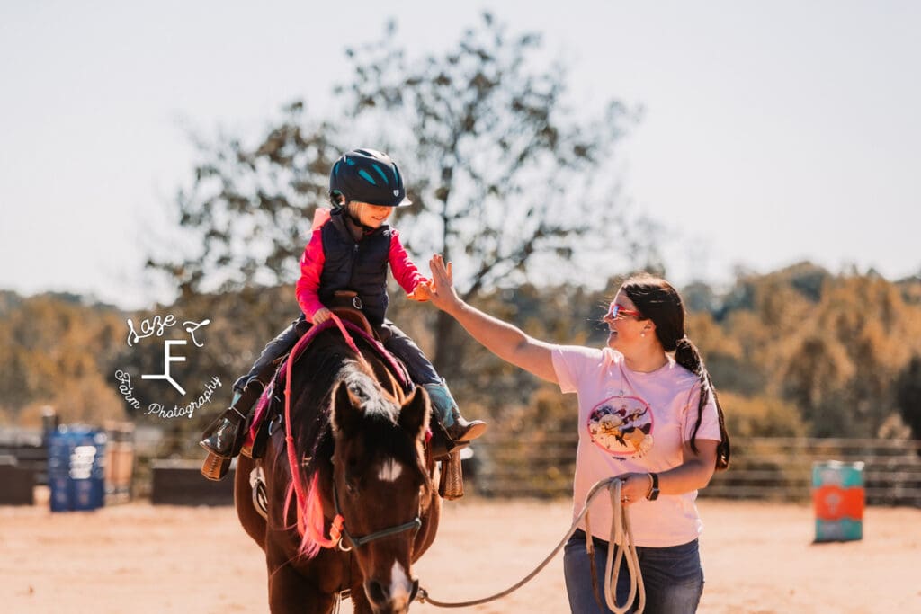 Rafter T Fun Show mom and daughter high fiving after run