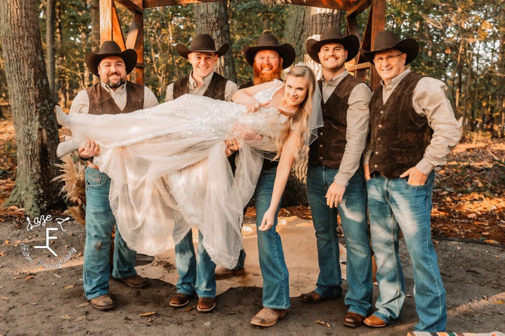 Groomsmen holding bride up