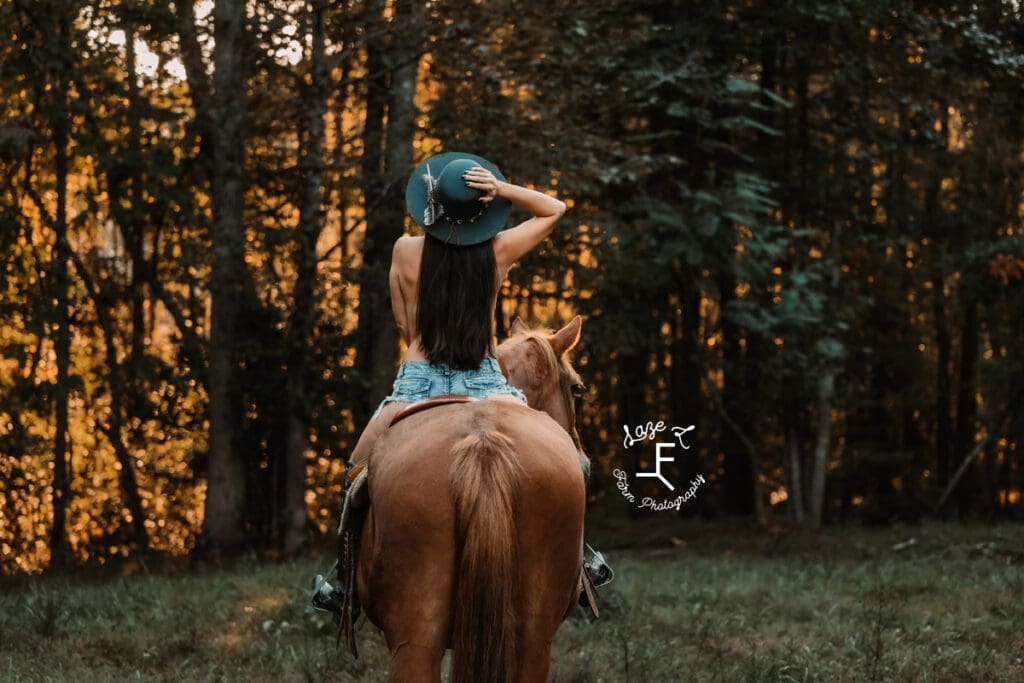 Sam riding Gus holding hat