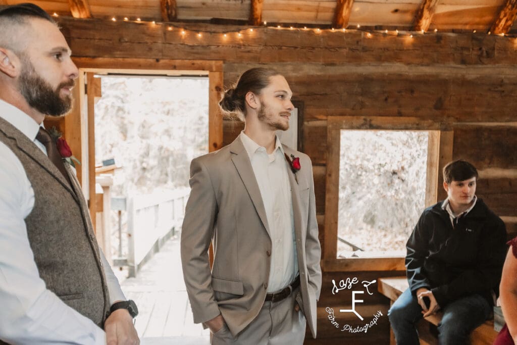 Groom watching bride come down the aisle