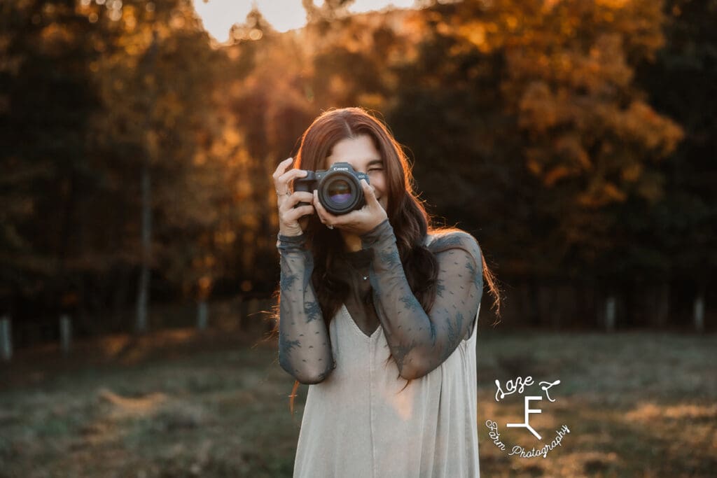 Gwen holding camera up to take a picture