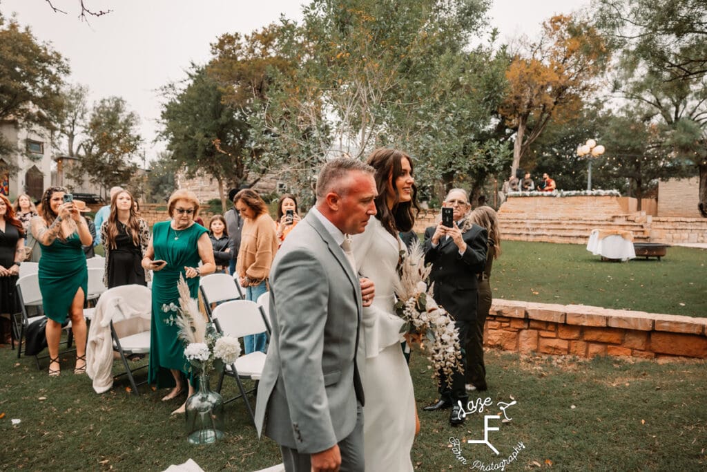 TX Wedding bride walking down aisle with her dad