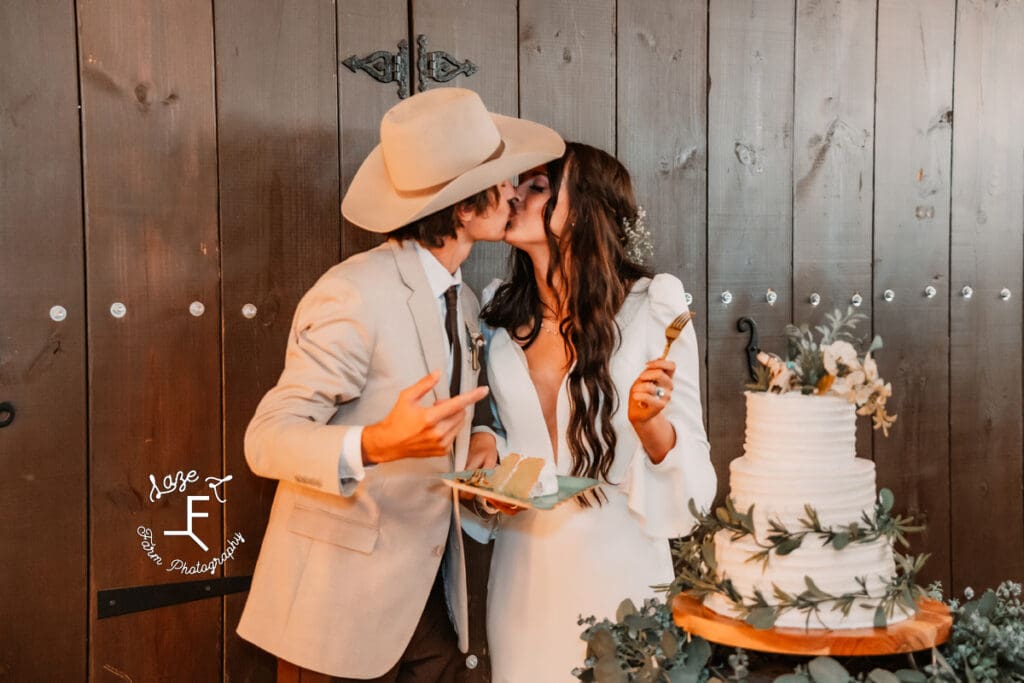 TX Wedding cake cutting kiss