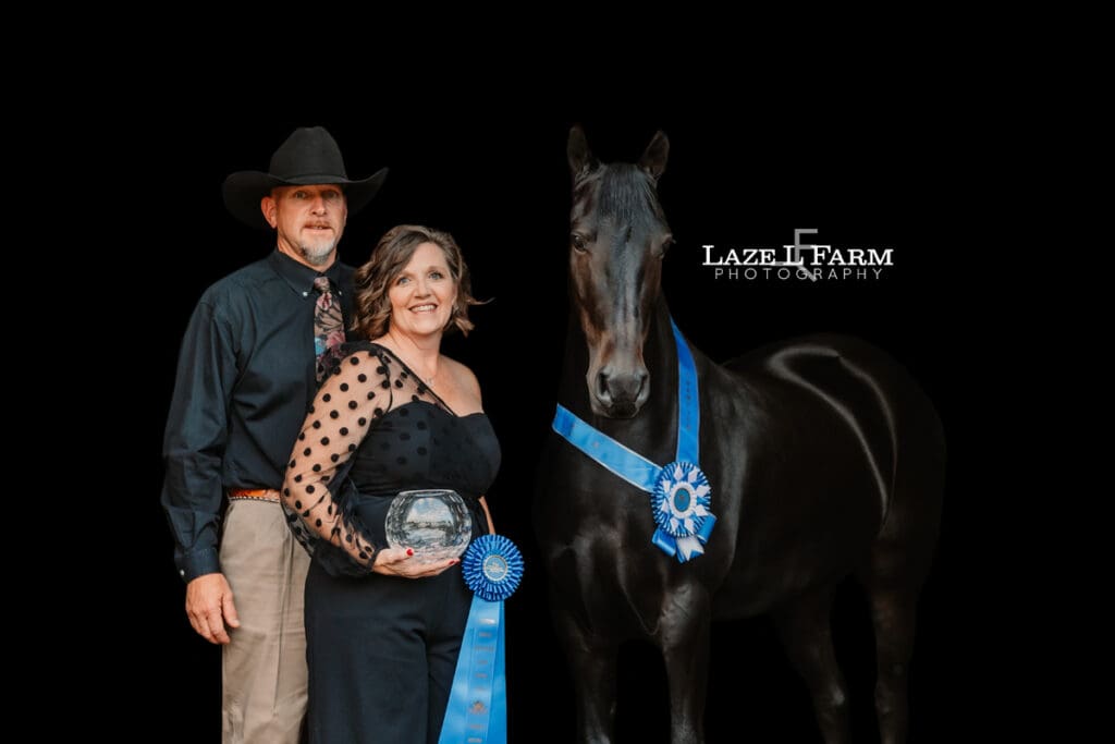 black background of a horse and their owners