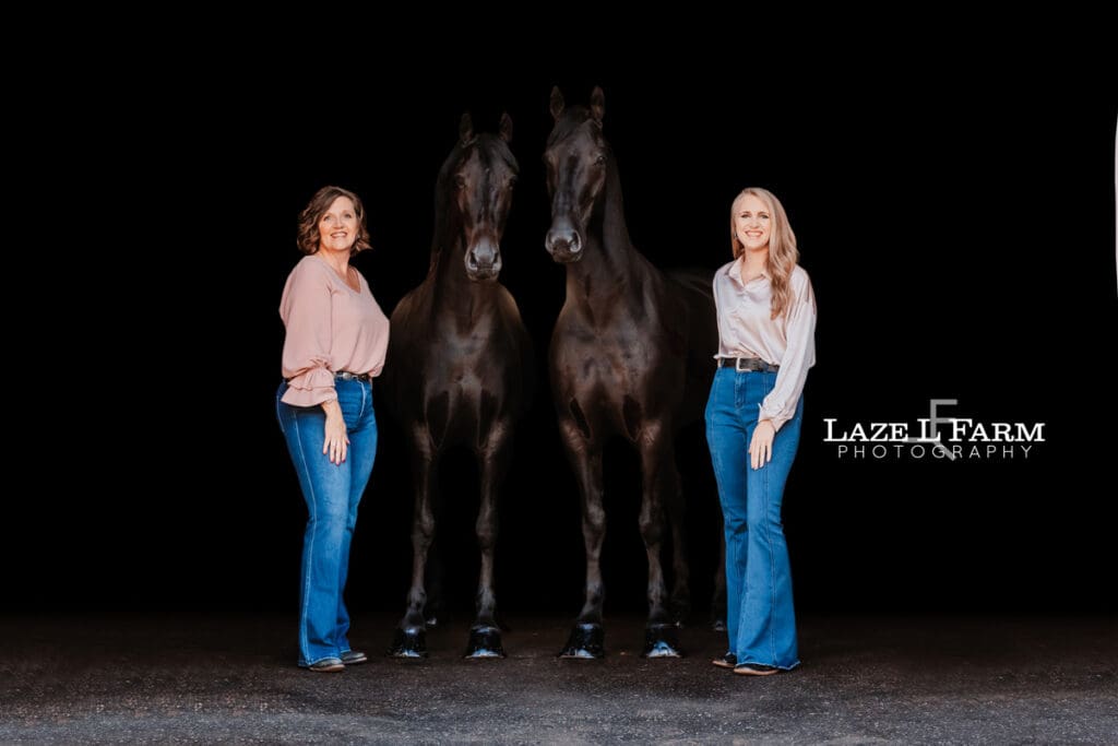black background of two horses and their owners