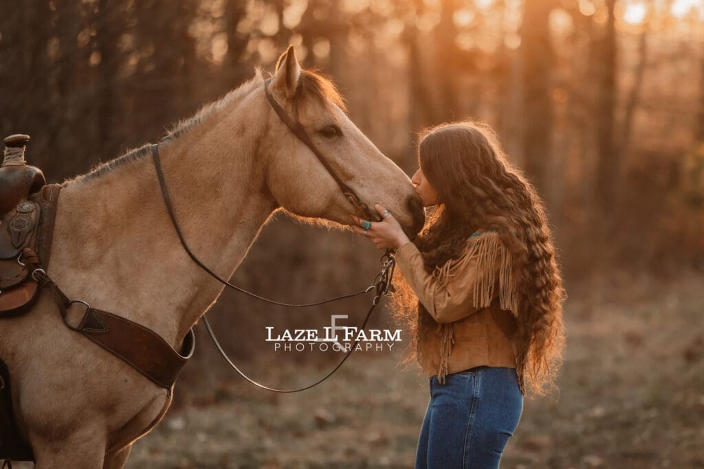 cowgirl kissing her horse