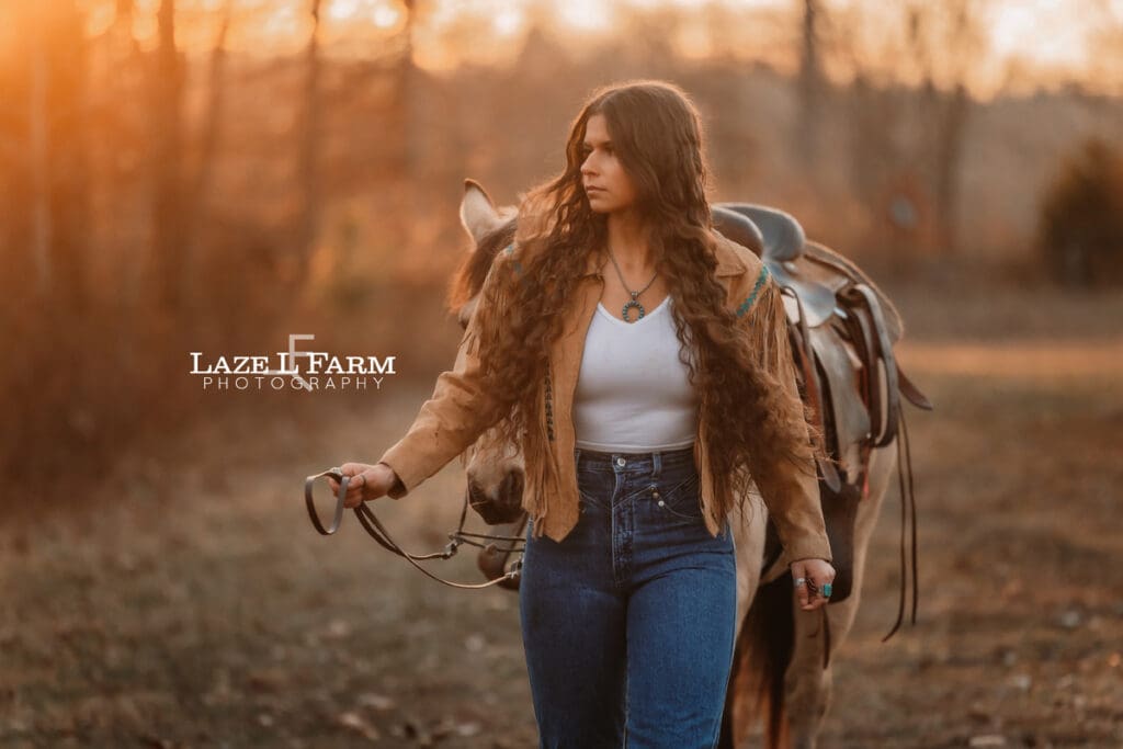 cowgirl walking with her horse