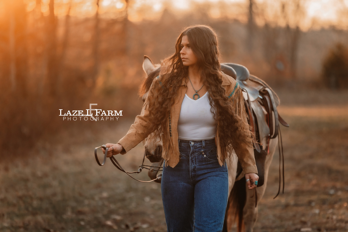 cowgirl walking with her horse