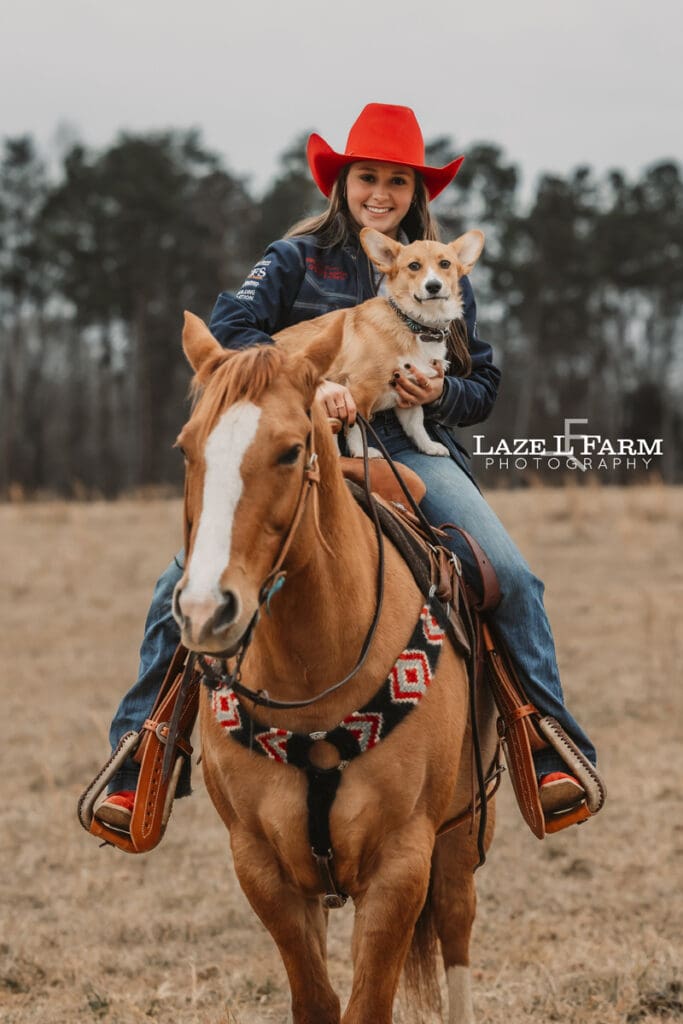 cowgirl sitting on her horse with her dog